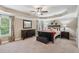 Spacious main bedroom with tray ceiling, elegant furnishings, and bedside tables at 6565 Bentley Ridge Dr, Cumming, GA 30040