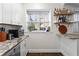 Open kitchen with white cabinets and a built-in bar creates an inviting spot to create culinary magic at 802 Frederica Ne St # 5, Atlanta, GA 30306