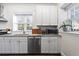Updated kitchen featuring white cabinets, stainless steel appliances, modern fixtures, and granite countertops at 802 Frederica Ne St # 5, Atlanta, GA 30306