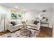 Bright living room featuring a comfortable L-shaped sofa, stylish rug, and hardwood floors at 802 Frederica Ne St # 5, Atlanta, GA 30306