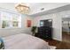 Comfortable main bedroom featuring a chandelier, large window, and stylish decor for a peaceful retreat at 802 Frederica Ne St # 5, Atlanta, GA 30306
