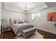 Serene bedroom features a chandelier, large window, and plush bedding, creating a relaxing retreat at 802 Frederica Ne St # 5, Atlanta, GA 30306