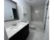 Clean bathroom with stylish vanity, modern fixtures, and shower with beautiful tile surround at 981 Dundee Dr, Lilburn, GA 30047