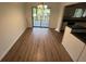 Open-concept dining area with sliding doors to a back deck and view of kitchen at 981 Dundee Dr, Lilburn, GA 30047