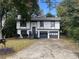 Charming two-story home with a well-manicured lawn and a two-car garage at 981 Dundee Dr, Lilburn, GA 30047