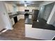 Modern kitchen featuring white cabinets, granite countertops and stainless steel appliances and flooring at 981 Dundee Dr, Lilburn, GA 30047