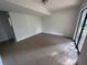 Bright living room features neutral tile flooring and sliding glass door access to the yard at 981 Dundee Dr, Lilburn, GA 30047