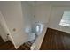 Stairway leading up to the entry door, featuring a white railing and neutral wall paint at 981 Dundee Dr, Lilburn, GA 30047