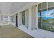 Long balcony with wooden floors, white railing, and decorative shutters on the windows at 1304 Six Sisters St, Dacula, GA 30019