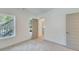 A bright room with grey walls, neutral-colored carpets, and view outside of the house at 1304 Six Sisters St, Dacula, GA 30019