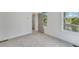 Bright bedroom with neutral carpet, white walls, and large windows showcasing the outdoor scenery at 1304 Six Sisters St, Dacula, GA 30019