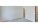 Neutral bedroom with carpet, white walls and trim, and a beige door at 1304 Six Sisters St, Dacula, GA 30019