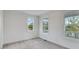 Unfurnished bedroom with carpet, three windows, and white trim at 1304 Six Sisters St, Dacula, GA 30019