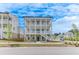 Striking three-story home featuring double balconies and a welcoming brick facade at 1304 Six Sisters St, Dacula, GA 30019