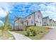 Beautiful two-story home with white siding, black roof and two car garage on a sunny day at 1304 Six Sisters St, Dacula, GA 30019