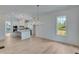 Open-concept kitchen with an island and modern stainless steel appliances and wood flooring at 1304 Six Sisters St, Dacula, GA 30019