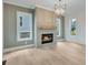 Cozy living room with fireplace, hardwood floors and modern chandelier at 1304 Six Sisters St, Dacula, GA 30019