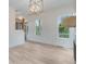 Spacious living room with hardwood floors, fireplace and modern chandelier at 1304 Six Sisters St, Dacula, GA 30019