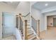 View of the house's staircase, featuring wooden steps, black iron railings, and light wood floors at 1304 Six Sisters St, Dacula, GA 30019