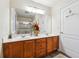Bathroom with double sinks, a large mirror, cherry wood cabinets, and a separate shower at 142 Jaime Dr, Canton, GA 30114