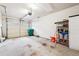 Spacious two-car garage with a concrete floor, storage shelves, and good overhead lighting at 142 Jaime Dr, Canton, GA 30114