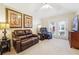 Inviting living room with leather seating, TV, and access to outdoor space at 142 Jaime Dr, Canton, GA 30114