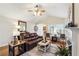 Open-concept living room boasting hardwood floors, fireplace, and bright natural lighting at 142 Jaime Dr, Canton, GA 30114