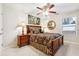 Well-lit main bedroom with elegant bed, side tables, and a ceiling fan at 142 Jaime Dr, Canton, GA 30114