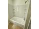 Shower and tub combination with shelving on a tile surround in the updated bathroom at 4030 Hiram Ct, Powder Springs, GA 30127