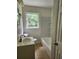 Bright bathroom with tiled floors, a large window, and a combined shower and tub at 4030 Hiram Ct, Powder Springs, GA 30127