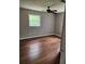 This bedroom offers hardwood floors and a ceiling fan at 4030 Hiram Ct, Powder Springs, GA 30127