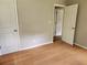 Neutral bedroom with hard wood floors and open doors at 4030 Hiram Ct, Powder Springs, GA 30127