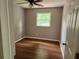 Cozy bedroom featuring neutral walls, hardwood flooring and natural light from the window at 4030 Hiram Ct, Powder Springs, GA 30127