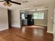 Open concept living room leading into kitchen featuring hardwood floors, neutral paint, and plenty of natural light at 4030 Hiram Ct, Powder Springs, GA 30127