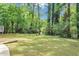 This home includes a spacious backyard with mature trees and lush green grass at 4261 Autumn Hill Dr, Stone Mountain, GA 30083