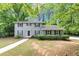 Traditional home with a manicured lawn, dark shutters, and a walkway leading to the front door at 4261 Autumn Hill Dr, Stone Mountain, GA 30083