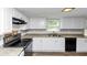 Kitchen features modern appliances, white cabinets, and a light-colored countertop, creating a welcoming and functional space at 4261 Autumn Hill Dr, Stone Mountain, GA 30083