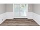 This living room boasts beautiful wainscotting, hardwood floors and glass doors at 4261 Autumn Hill Dr, Stone Mountain, GA 30083