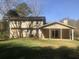 View of a two-story home featuring a backyard with a covered patio and large grassy area at 432 Rock Meadow Dr, Stone Mountain, GA 30088