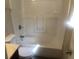 Clean bathroom featuring a white bathtub with shower and toilet with a marble-look vanity at 432 Rock Meadow Dr, Stone Mountain, GA 30088