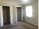 Bedroom featuring carpet floors, two closets, and natural light from a window at 432 Rock Meadow Dr, Stone Mountain, GA 30088