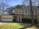 Two story house with a stone facade, lawn, and a two car garage at 432 Rock Meadow Dr, Stone Mountain, GA 30088
