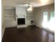 Living room with fireplace, wood floors, a ceiling fan, and built in bookshelves at 432 Rock Meadow Dr, Stone Mountain, GA 30088