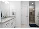 Bright bathroom with a glass shower, a double sink vanity, granite countertop and white cabinets at 64 Emerson Hill Sq, Marietta, GA 30060