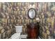 Stylish half bathroom with wallpaper, hardwood floors, and a decorative mirror at 64 Emerson Hill Sq, Marietta, GA 30060