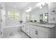 Bright bathroom with a soaking tub, double sink vanity with granite countertop and white cabinets at 64 Emerson Hill Sq, Marietta, GA 30060
