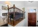 Inviting entryway featuring hardwood floors, dark wood door, and an iron railing at 64 Emerson Hill Sq, Marietta, GA 30060