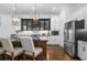 Elegant kitchen featuring a central island, modern lighting, and stainless steel appliances at 64 Emerson Hill Sq, Marietta, GA 30060