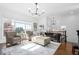 Bright living room with hardwood floors and large windows, offering scenic views at 64 Emerson Hill Sq, Marietta, GA 30060
