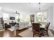 Bright living room featuring many windows, hardwood floors, and an open-concept dining area at 64 Emerson Hill Sq, Marietta, GA 30060